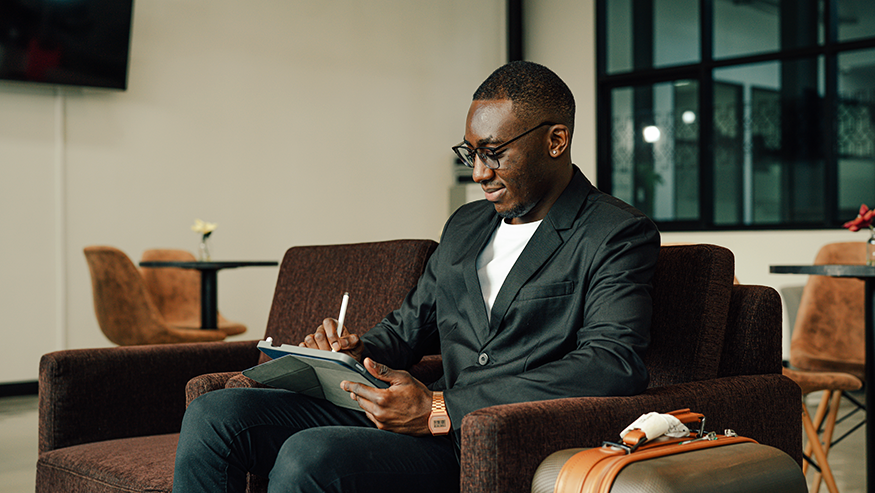 Employee working on tablet in airport lounge